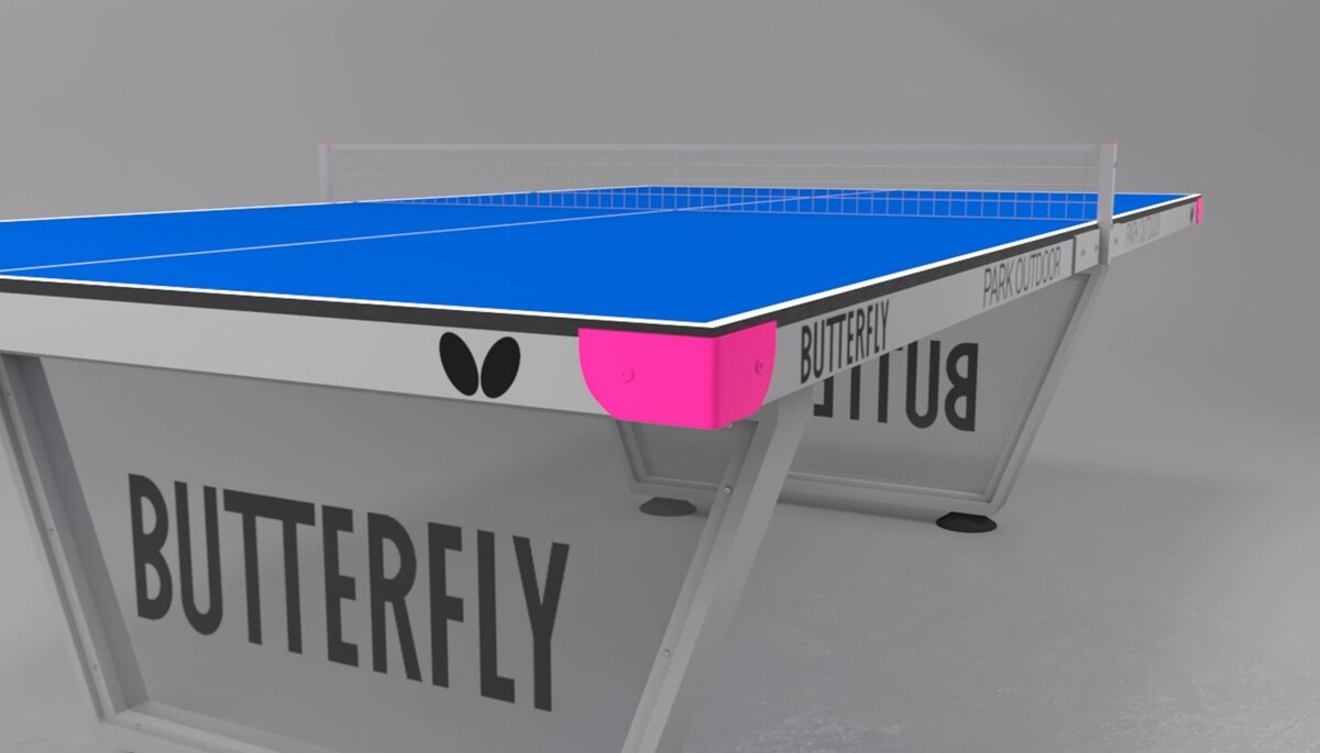 Butterfly Park Outdoor Ping Pong Table, pictured, has clear covering between the end legs with a Butterfly logo printed in black. Also shows pink end caps with wing and word logo printed on rails.